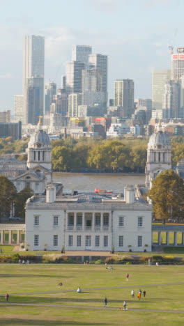 Vertical-Video-Of-Old-Royal-Naval-College-With-City-Skyline-And-River-Thames-Behind-From-Royal-Observatory-In-Greenwich-Park